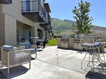 Outdoor grill area with modern seating and mountain views